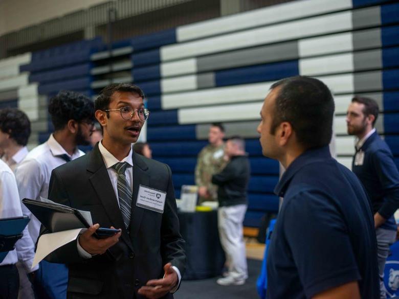 Penn State Abington (near Philadelphia) student talking to employeer at career fair 